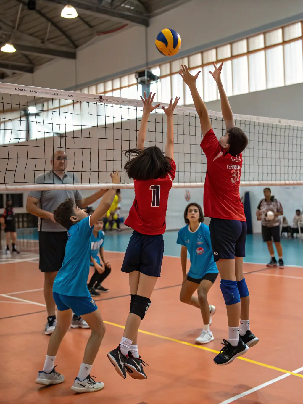 A dynamic shot of young volleyball players in action during a training session, showcasing their energy and teamwork.